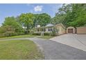 Quaint one-story home with a covered front porch and detached garage on a well-manicured lot at 502 Allen Dr, Lawrenceville, GA 30043