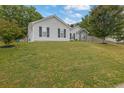 Charming single-story home with light siding, dark shutters, and a well-manicured lawn at 507 Hillcrest Cross Rd, Canton, GA 30115