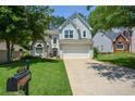 Charming two-story home with a well-manicured lawn, mailbox, and a two-car garage at 1777 Chasewood Park Ln, Marietta, GA 30066