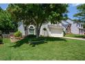 Landscaped front yard with green lawn and mature tree shading the two-story home at 1777 Chasewood Park Ln, Marietta, GA 30066