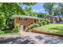 Charming brick ranch home with a basement entrance, set back from the street on a grassy lot at 2201 Bollingbrook Drive, Atlanta, GA 30311