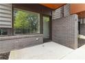 Cozy outdoor patio area with brick walls, concrete flooring, and views of the surrounding greenery at 367 Parkway Ne Dr # 4, Atlanta, GA 30312