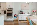 Bright kitchen nook featuring a breakfast bar, stainless steel double oven, and an adjacent dining area at 996 Layton Dr, Buford, GA 30518