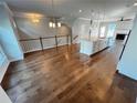 Open-concept living room boasts hardwood floors, island, and staircase at 996 Layton Dr, Buford, GA 30518