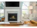 Inviting living room featuring a fireplace, ample natural light, and cozy furnishings, creating an ideal space for relaxation at 996 Layton Drive Dr, Buford, GA 30518