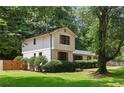 Charming two-story home featuring a blend of painted brick and wood siding at 3308 Quail Sw Run, Marietta, GA 30008