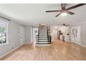 Open-concept living space with wood floors, modern ceiling fans, and staircase views to the kitchen at 3308 Quail Sw Run, Marietta, GA 30008