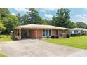 Single-story brick home with a covered carport and long driveway at 4065 Old Austell Rd, Powder Springs, GA 30127