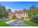 A grand brick home with a well-manicured front lawn and long driveway at 7523 Kimberly Lynn Ct, Lithonia, GA 30058