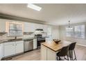 Modern kitchen with stainless appliances, white cabinets, granite counters, and a cozy breakfast bar at 840 Wells Se Cir, Smyrna, GA 30080