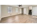 Expansive living room featuring beautiful laminate floors, two bright windows, and neutral colored walls at 840 Wells Se Cir, Smyrna, GA 30080