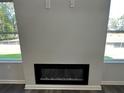Close-up of a contemporary fireplace with a sleek black finish, creating a cozy focal point in the living space at 115 Heyman Dr, Covington, GA 30016