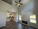 Spacious living room featuring high ceilings, a modern fireplace, and dark wood floors, blending comfort and style at 115 Heyman Dr, Covington, GA 30016