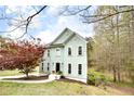 Charming two-story home boasts light green siding, black front door, and a landscaped yard at 1772 Brittany Chase Nw, Kennesaw, GA 30152