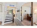 Inviting entryway with staircase, stylish rug, and an arched doorway leading to a bright, well-lit room at 1450 Rainfall Ct, Cumming, GA 30040