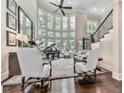 Elegant living room with floor-to-ceiling windows, a grand piano, and stylish decor at 5039 Towne Lake Hills North, Woodstock, GA 30189
