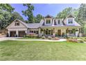 Beautiful two-story home boasting a cozy front porch and well-manicured front yard at 125 Foxridge Rd, Atlanta, GA 30327