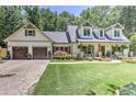 Attractive two-story home with an attached garage and meticulously maintained lawn at 125 Foxridge Rd, Atlanta, GA 30327