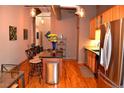 Open concept kitchen with stainless steel refrigerator and central island with barstool seating at 172 Haynes Sw St # 107, Atlanta, GA 30313