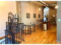 Open-concept view of staircase and kitchen area with dining table, island, and hardwood floors at 172 Haynes Sw St # 107, Atlanta, GA 30313