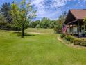 Lush front yard with mature trees and a well-maintained lawn leading to the home at 3769 Bay Creek Church Rd, Loganville, GA 30052
