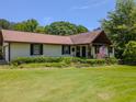 Ranch-style home with a manicured lawn, garden, and a charming front porch at 3769 Bay Creek Church Rd, Loganville, GA 30052