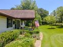 Landscaped front yard featuring a stone walkway, green grass, and an American flag at 3769 Bay Creek Church Rd, Loganville, GA 30052