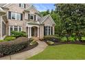 Close-up of a brick home featuring lovely landscaping and an inviting walkway at 8970 Moor Park Run, Duluth, GA 30097
