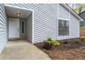 A welcoming front entrance with a well-kept garden bed adds charm to this lovely home at 1360 Terramont Dr, Roswell, GA 30076
