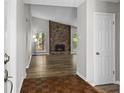 Inviting living room showcasing hardwood floors, a cozy fireplace, and abundant natural light from the windows at 1360 Terramont Dr, Roswell, GA 30076