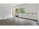 Bright entryway with neutral walls, gray tile flooring, big window and access to staircase at 367 Parkway Ne Dr # 5, Atlanta, GA 30312