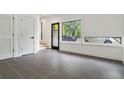A modern living room with gray ceramic tile, natural light, and white trim at 367 Parkway Ne Dr # 5, Atlanta, GA 30312