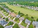 Aerial view of homes in a lush, landscaped neighborhood near green space and mature trees at 5365 Glenhaven Dr, Cumming, GA 30041