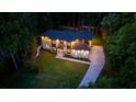 Aerial view of a home at dusk with professional lighting and a well maintained green lawn at 942 Fairfield, Marietta, GA 30068
