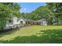 Beautiful white exterior home with well-manicured lawn and a welcoming front porch lined with rocking chairs at 1031 Bailey Rd, Woodstock, GA 30188