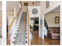Inviting foyer with staircase, hardwood floors, and high ceilings that create a grand entrance at 242 Sandhurst Ct, Suwanee, GA 30024