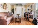 Cozy living room features hardwood floors, a comfortable sofa, and a bright workspace at 242 Sandhurst Ct, Suwanee, GA 30024