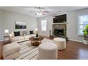 Bright living room featuring a fireplace, hardwood floors, lots of light and neutral-colored furniture at 2918 Pavia Circle, Austell, GA 30106