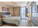 Bedroom featuring a comfortable bed, city views, and contemporary furnishings at 3040 Peachtree Nw Rd # 1013, Atlanta, GA 30305