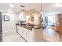 Open kitchen with granite countertops, stainless steel appliances, and bar seating at 3040 Peachtree Nw Rd # 1013, Atlanta, GA 30305