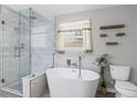 Modern bathroom features a soaking tub, glass enclosed shower, and stylish tile work at 4038 Sharon Woods Dr, Powder Springs, GA 30127