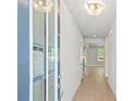 Bright and airy hallway with light hardwood floors and neutral paint, leading to the main living areas at 910 Melody Ridge Ln, Buford, GA 30518