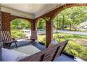 Relaxing porch with seating, a swing, and views of the manicured lawn and garden at 1055 Woodland Se Ave, Atlanta, GA 30316