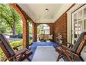 Inviting porch with brick arches, seating, and a porch swing for relaxing outdoors at 1055 Woodland Se Ave, Atlanta, GA 30316