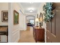 Elegant foyer featuring wood floors and a decorative wreath on the front door at 2920 Farmstead Way, Suwanee, GA 30024