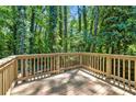 Wooden deck featuring new wood and providing a view of the surrounding lush greenery and trees at 5115 Leland Dr, Stone Mountain, GA 30083