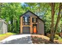 View of the home's exterior showing the brick and siding, set among mature trees and landscaping at 5115 Leland Dr, Stone Mountain, GA 30083