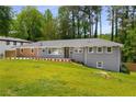 Inviting single-story home with lush green lawn and meticulously maintained landscaping at 681 Fielding Sw Ln, Atlanta, GA 30311