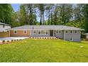 Charming single-story home featuring a well-manicured lawn and newly planted landscaping at 681 Fielding Sw Ln, Atlanta, GA 30311
