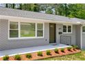 Close-up of well kept home featuring manicured landscaping and a welcoming entryway at 681 Fielding Sw Ln, Atlanta, GA 30311